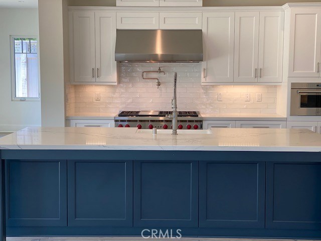 Completely Customized Kitchen with Subzero appliances, upgraded white cabinets, upgraded Quartz countertops, upgraded porcelain sink, farmhouse faucet, and pot filler.