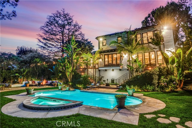 Expansive back yard with pool.spa,fire pit and granite rock seating area