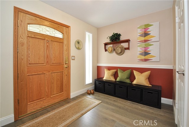 A Spacious Entry Hall with a Coat Closet and Wide Plank White Oak Distressed Floors