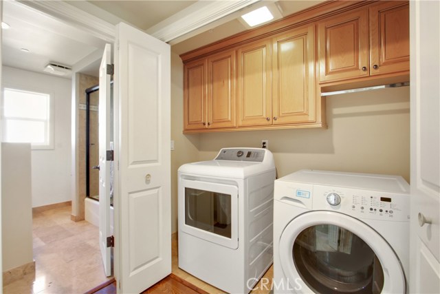 WASHER & DRYER ROOM WITH BUILT IN CABINETS.