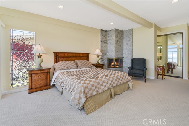 Master bedroom has leaded beveled glass windows, mirrored closet doors and vanity.