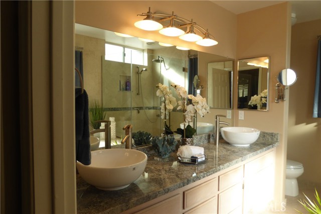 Master Bath with new granite, fixers, top mounted basins & lighting.