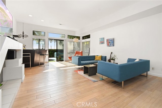 Lower level family room with fireplace, bar, and access to the backyard.