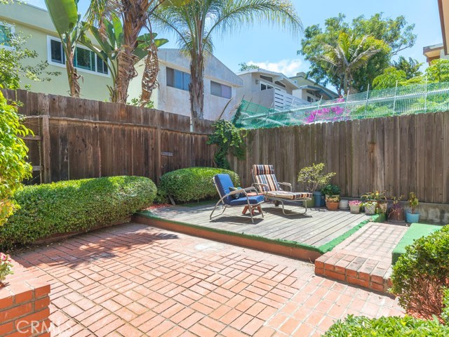 Brick and deck surface area in backyard, gets plenty of light.