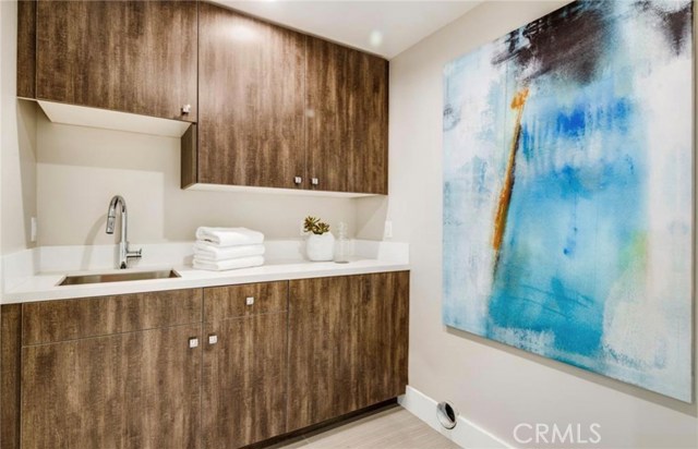 The laundry room is on the second level and features a utility sink and folding area