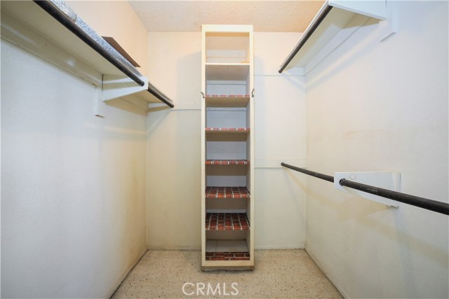 The Large Walk-in Closet has Shelving and Multiple Clothes Hanging Rails to Accommodate a Large Wardrobe.