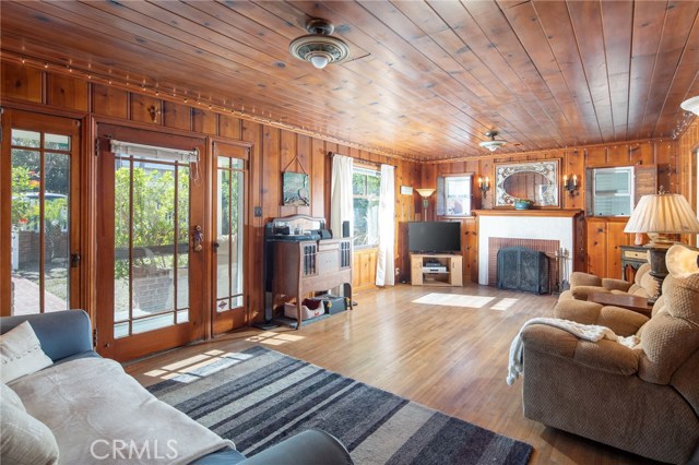 Front door is beautiful, original Craftsman door. Living room has original hardwood floors and wood burning fireplace. Ceiling light fixtures are original with beautiful detail.