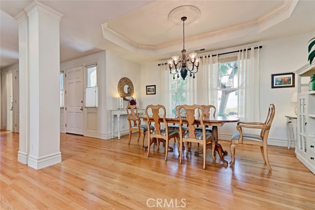 Formal dining room with custom alcove ceiling and hardwood floors.