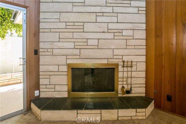 The impressive floor to ceiling full wall fireplace is a focal point with it's stone facing and raised slate hearth.