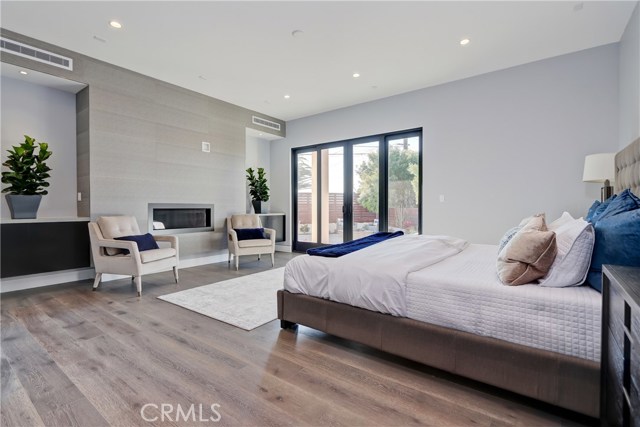 37. Stone wall fireplace flanked by shelves for your featured artwork