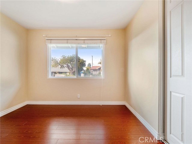 Bedroom #3 with hardwood floors and custom closet built ins.