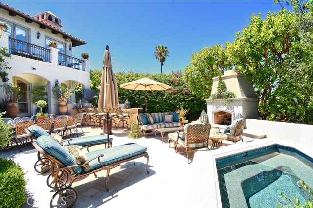 Resort-like yard with spa, kitchen, fireplace and fountain.