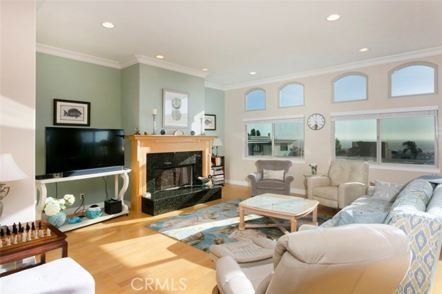 Living room on top level of home with standing and sitting ocean views