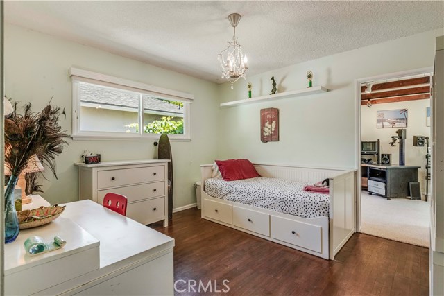 Bedroom #3 features hardwood flooring and is adjacent to the bonus room/office