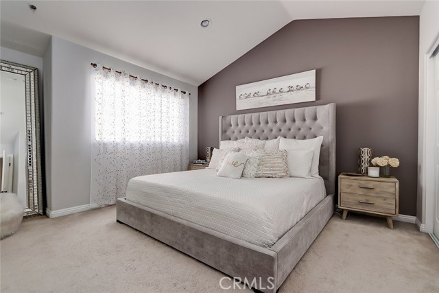 Light and bright master bedroom with vaulted ceilings.