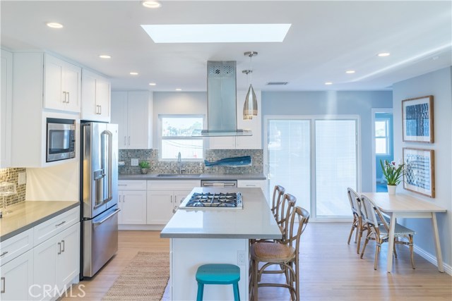 The stainless steel appliances are stunning and you'll love the designer tile backsplash.  A walk-in pantry is behind the refrigerator.