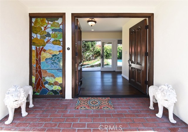 Enter via double doors to a spacious entry which flows out to the patio and pool with large halls on either side that access the rest of the home