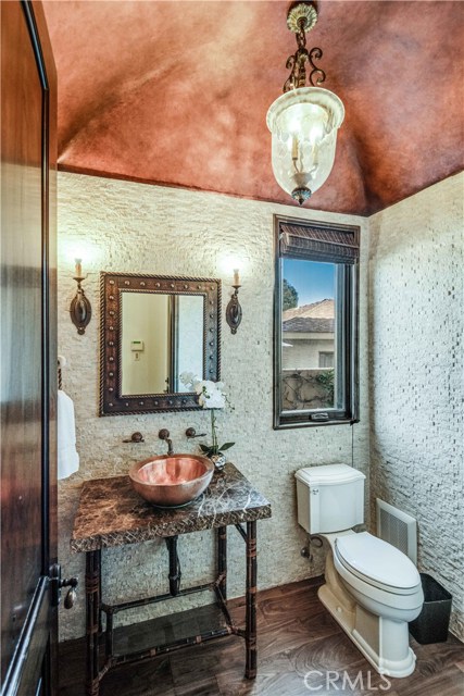 Powder bath #1 off kitchen with copper sink and rock wall