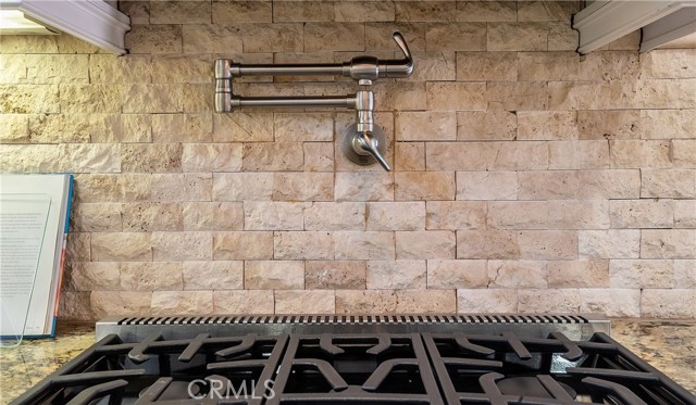 Stone backsplash, featuring handy pot-filler over the Viking stove.