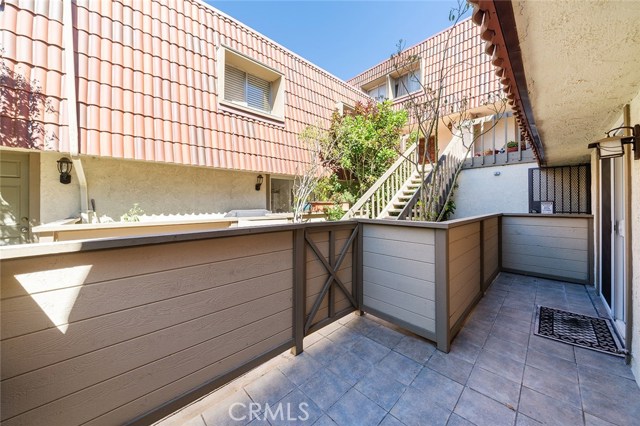 Outdoor patio off of the Kitchen and Living room. Entrance to the garage with 2 side by side parking spaces and 4 large storage lockers just steps away.