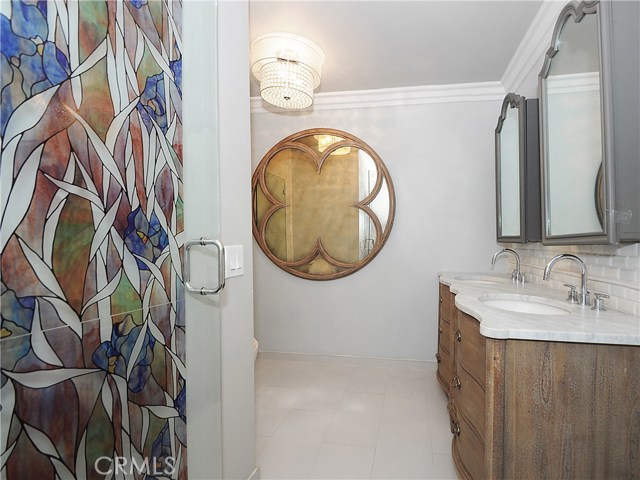 Bathroom one with stained glass door and double vanity