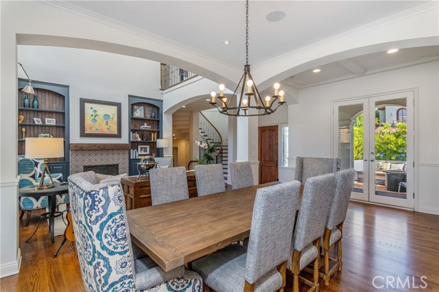 The dining room opens onto the Formal Living Room, note the double doors open onto a private side patio