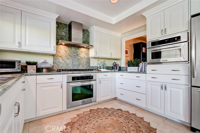 Stainless steel appliances include a six burner Viking range and built-in microwave.