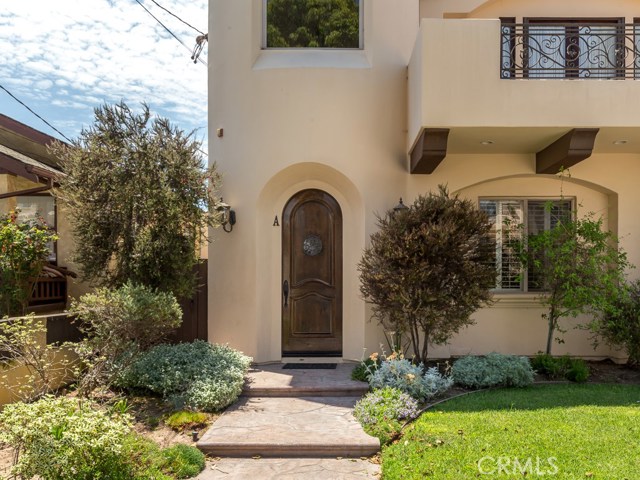 Inviting landscaping and gorgeous hardwood entry door!