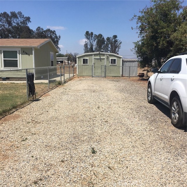 Large gravel drive can park many cars. storage shed.