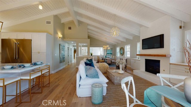 look at the size of the great room. the detail of the beamed ceiling, so much sunlight creates an airy feeling.  the formal dining room in the distance.