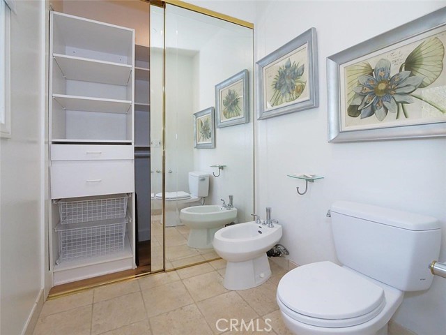 Water closet in master bathroom with extra closet for dirty laundry and storage