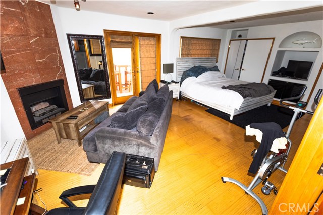 Spacious Master Bedroom with Fireplace and Hardwood floors.