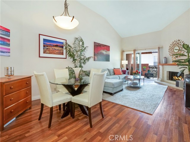 Dining and Living area with cathedral ceiling and fireplace open onto your own patio.