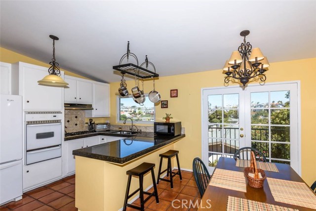 Lovely remodeled kitchen with dining area overlooking the neighborhood view.