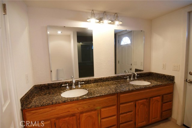 Bottom level full bath with double sinks, granite counter tops and plenty of storage.