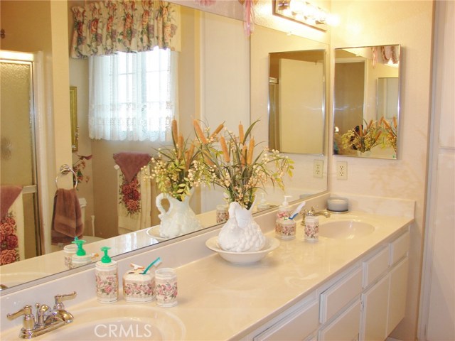 PRIVATE MASTER BATHROOM OFFERS A LARGE VANITY CABINET WITH 2 SINKS AND EXTRA COUTERTOP SPACE.