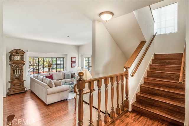Looking down from 2nd living area into the front living room. Stairs up to 3 bedrooms. Stairs down to large 3 car garage and huge bonus room; perfect for 4th bedroom or man cave.