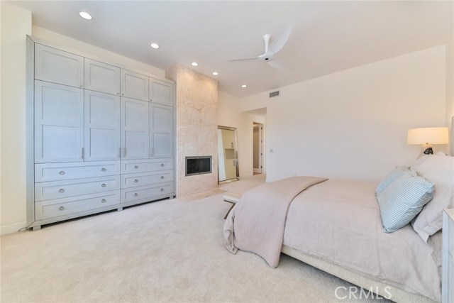 master bedroom with new custom built in cabinets and modern fireplace