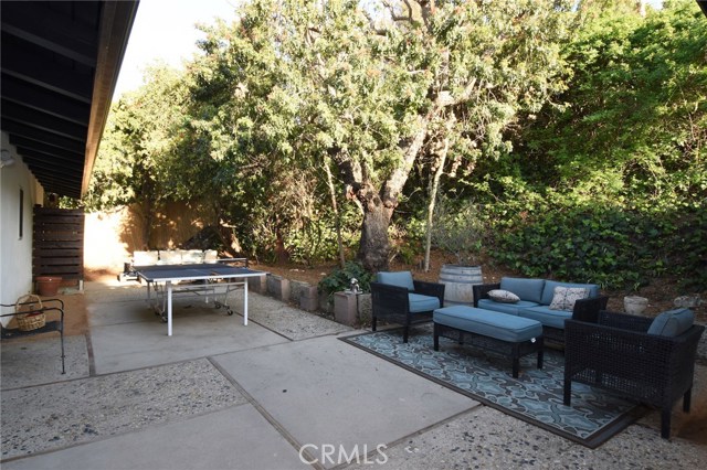 Pretty side yard!  Beyond on the left is a custom built in outdoor shower with hot & cold water