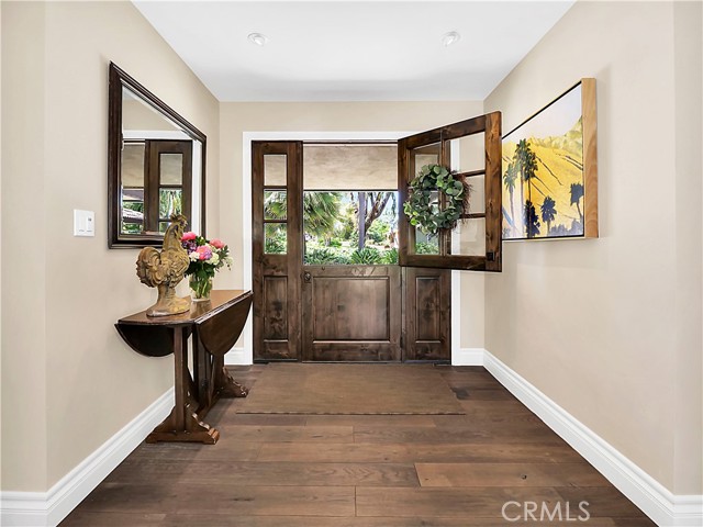 Welcoming entry with white oak hardwood floors throughout the home