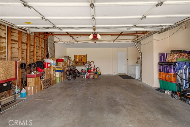 The garage in 25' long which is 5' longer than standard. Build a workshop, studio or office in the space. Also the garage is wider than standard with extra width on right side of picture. Direct access to interior and laundry area at right.