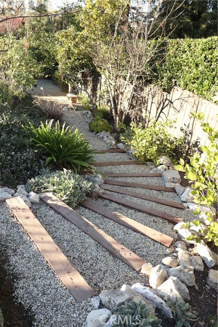 Timber steps leading to a hidden garden area