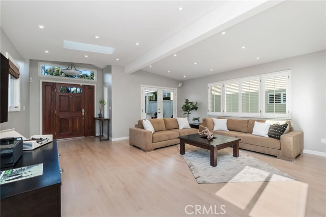 Entry and Living Room with french doors opening up to patio and yard.  Vaulted ceilings, tons of light and AC await inside.