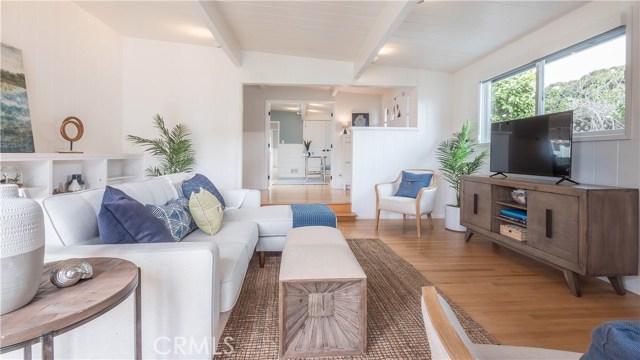 Living room with fireplace and refinished wood floors