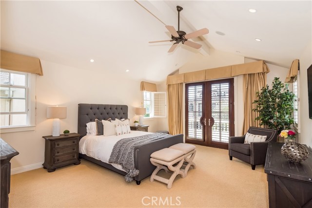 Large Master Suite with vaulted ceilings, French Doors, and a balcony that overlooks the walk street.