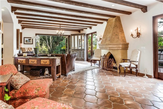 Living room with balcony and wood French doors to side patio