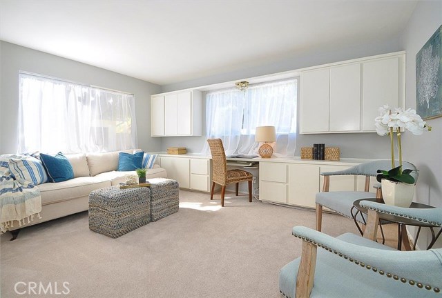 First bedroom with built-in desk and cabinets.