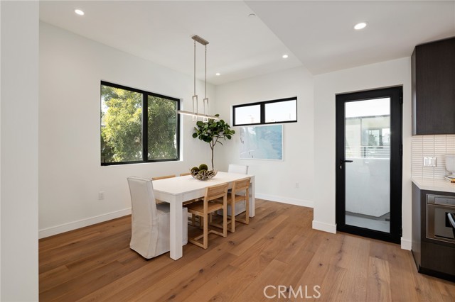 Adjacent dining space filled with natural light and a French door leading to extraordinary views (shown here using reverse of 961 Unit A staging)