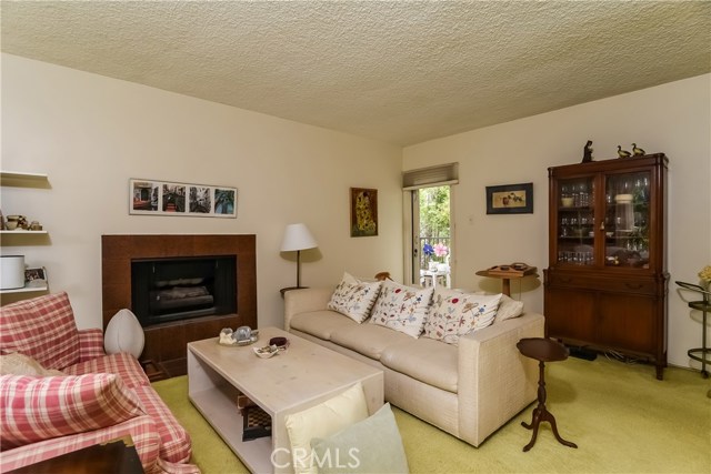 Family room with fireplace, wet bar and balcony with ocean view.