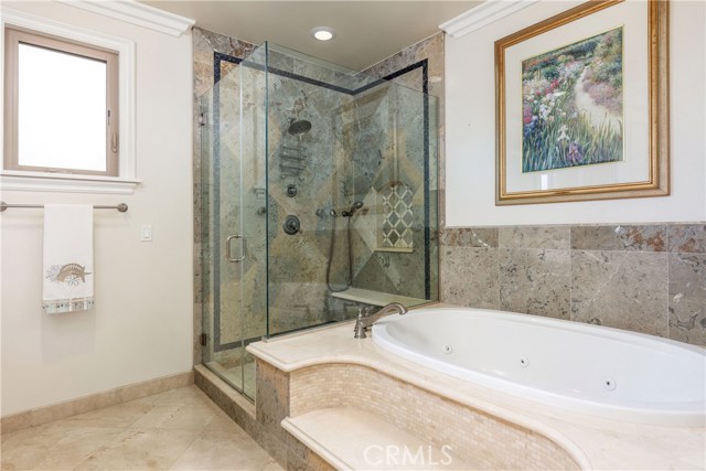 Sit down glass shower and spa tub.